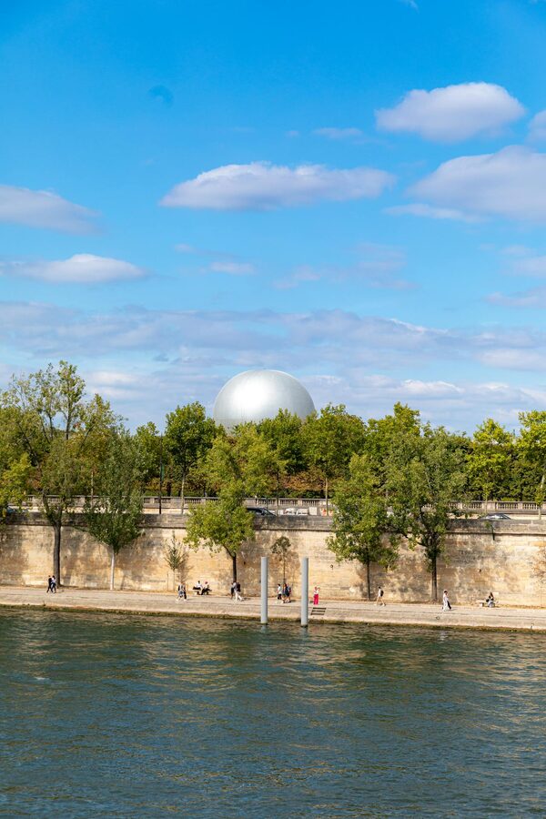 La Geode behind trees along the river