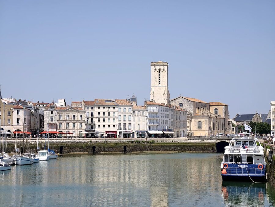 La Rochelle harbor with boats and historic buildings under blue sky