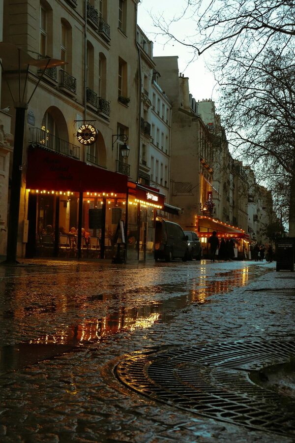 Paris cafe at dusk in the Latin Quarter with illuminated street