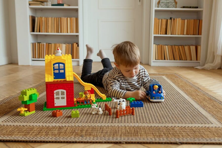 Child with colorful LEGO building blocks