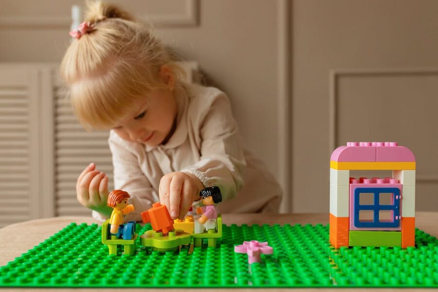 Young girl playing with LEGO blocks