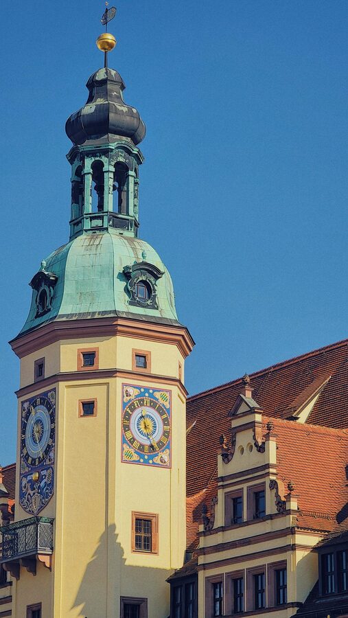 Historic bell tower in Leipzig under blue sky