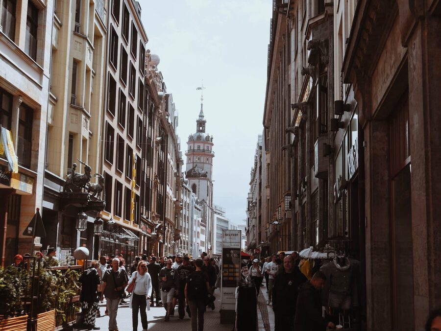 Lively urban street in Leipzig with people and historic architecture