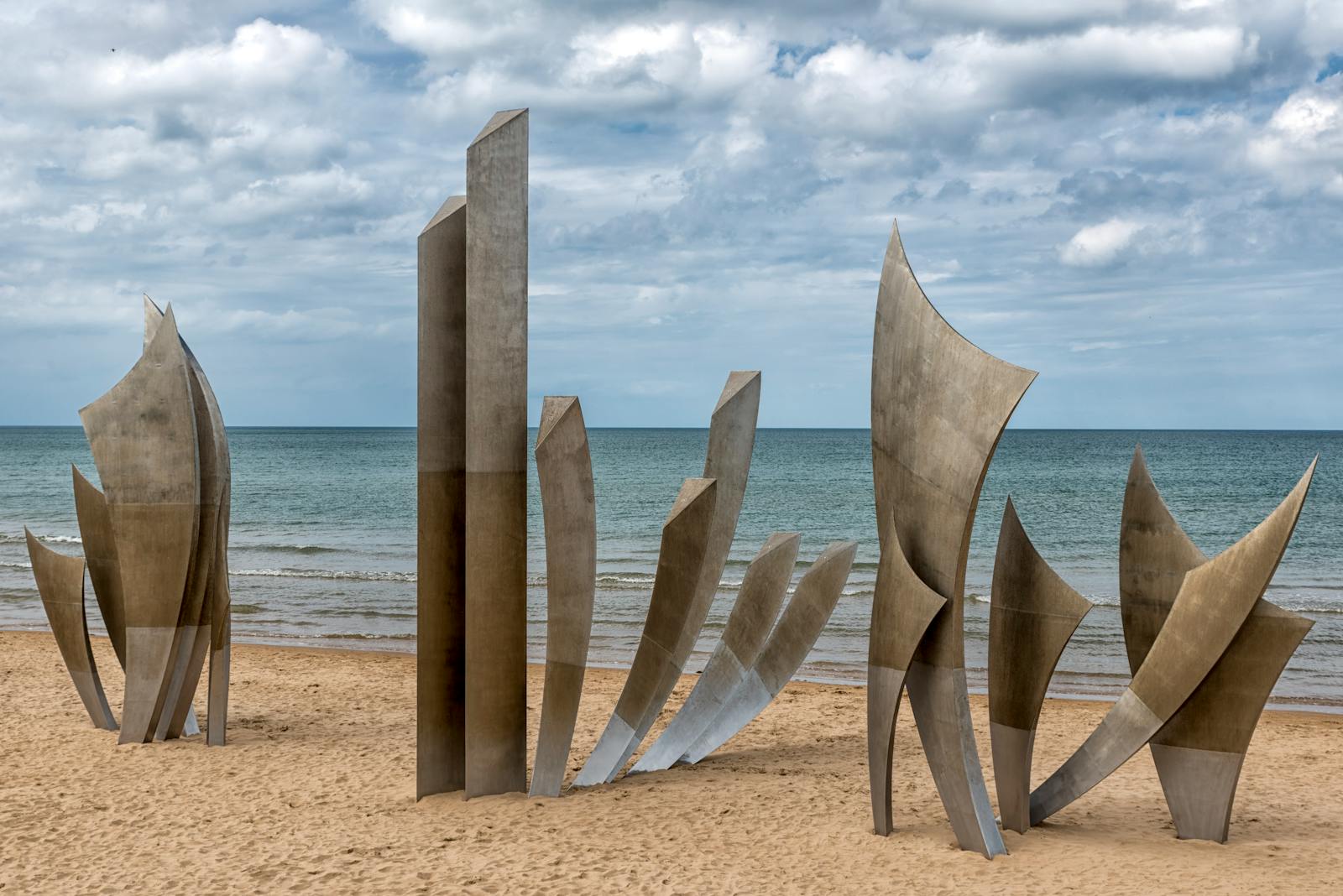 Les Braves Memorial standing on the sand of Omaha Beach in Normandy