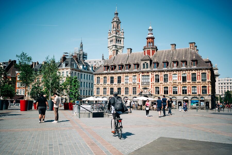 City square in Lille with historic architecture and people on a sunny day