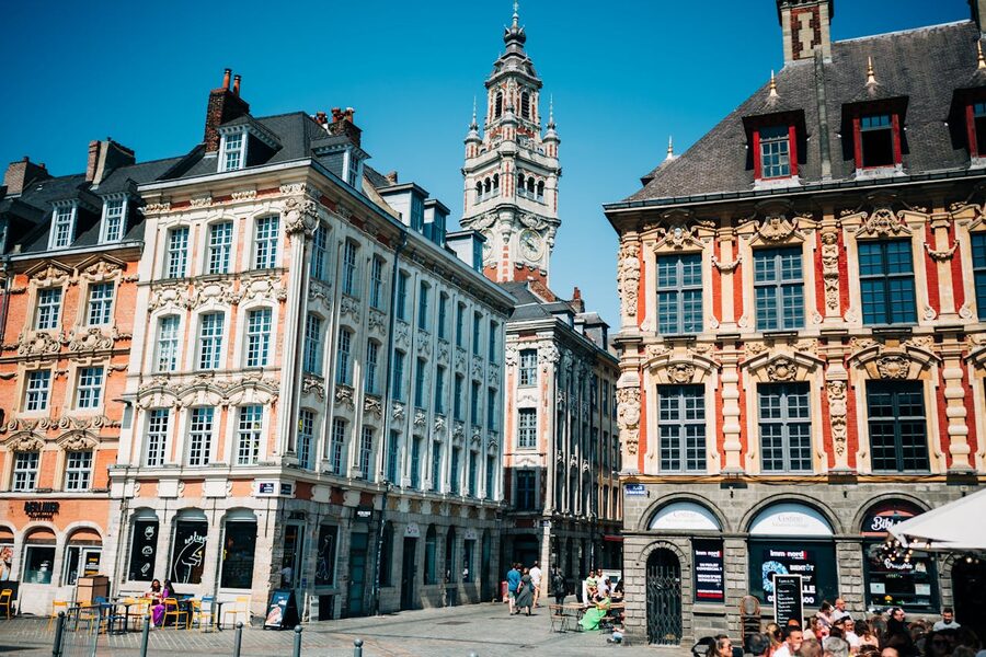Ornate townhouses and belfry in Lille Grand Place on a sunny day