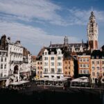 Colourful buildings at Lille Grand Place under blue sky