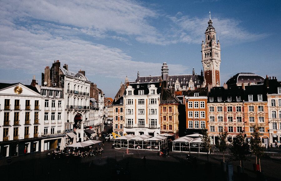 Colourful buildings at Lille Grand Place under blue sky