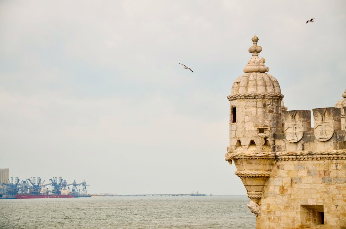 Belém Tower on the Tagus River in Lisbon with birds in flight