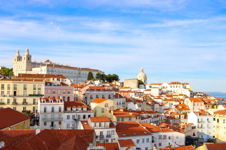 Lisbon cityscape with colorful rooftops and river in the distance