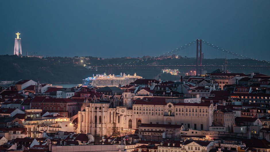 Panoramic view of Lisbon at night with illuminated buildings