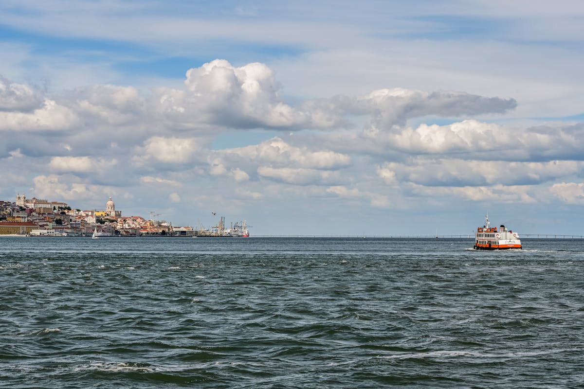 Ferry crossing the Tagus River with Lisbon skyline in the background