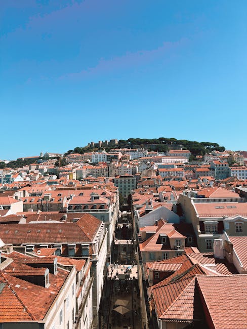 Historic yellow tram on a narrow Lisbon street