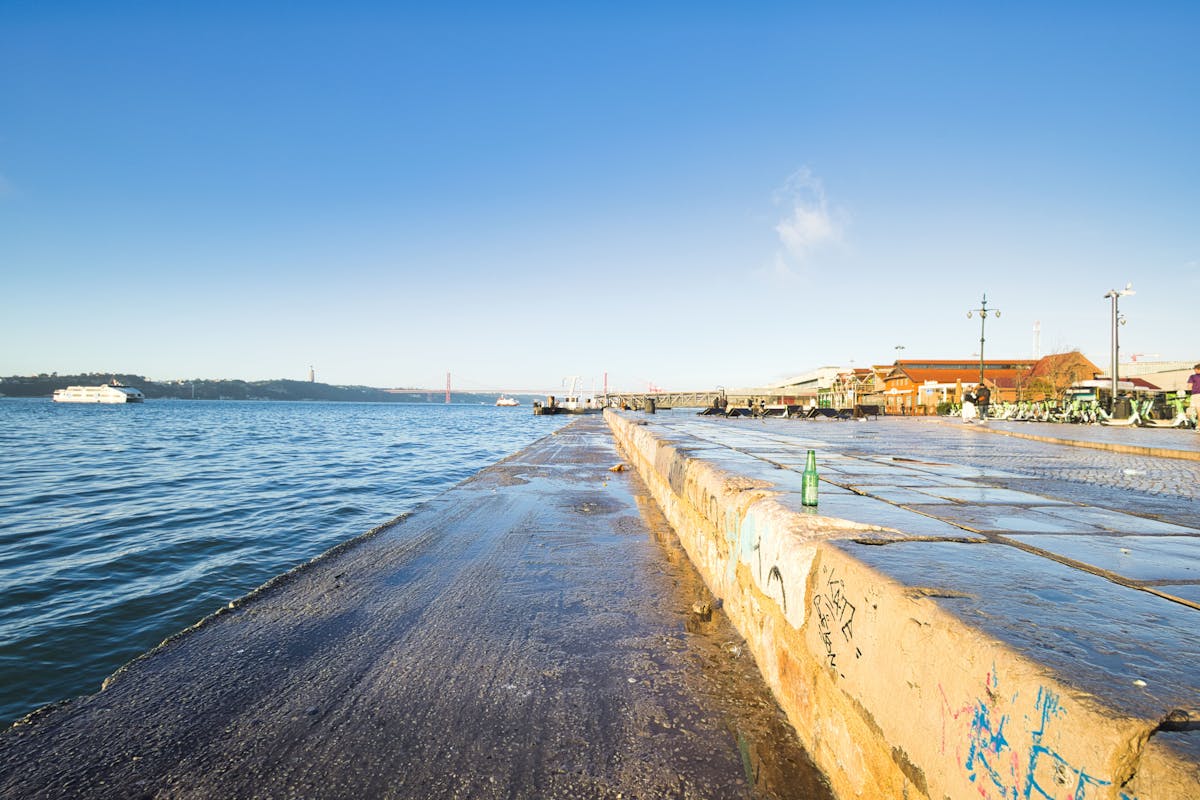 Lisbon waterfront with boats and clear skies