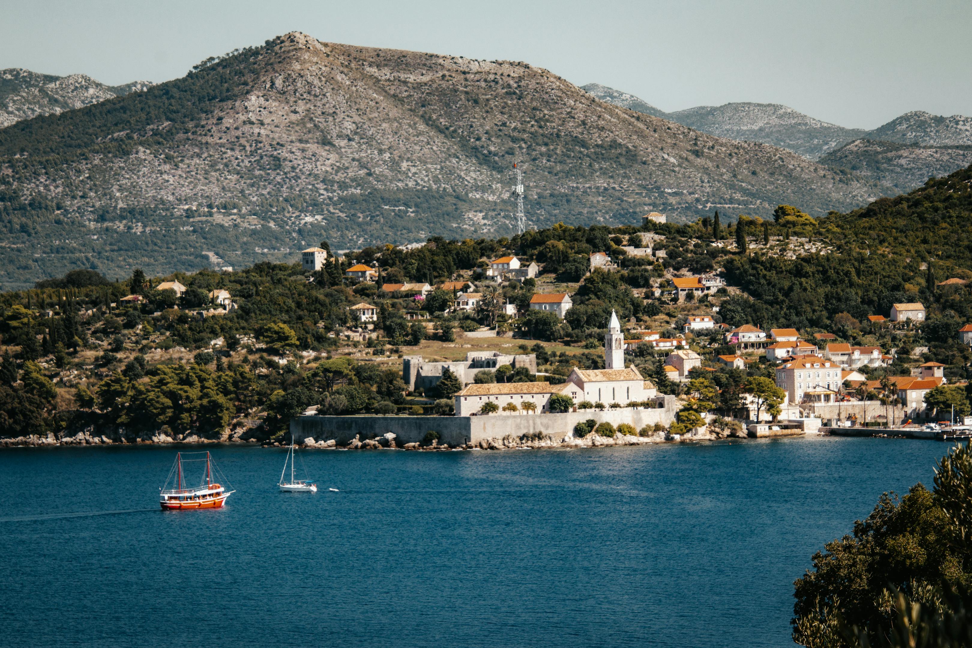 Picturesque scene of Lopud Island showcasing boats, hills, and a charming town