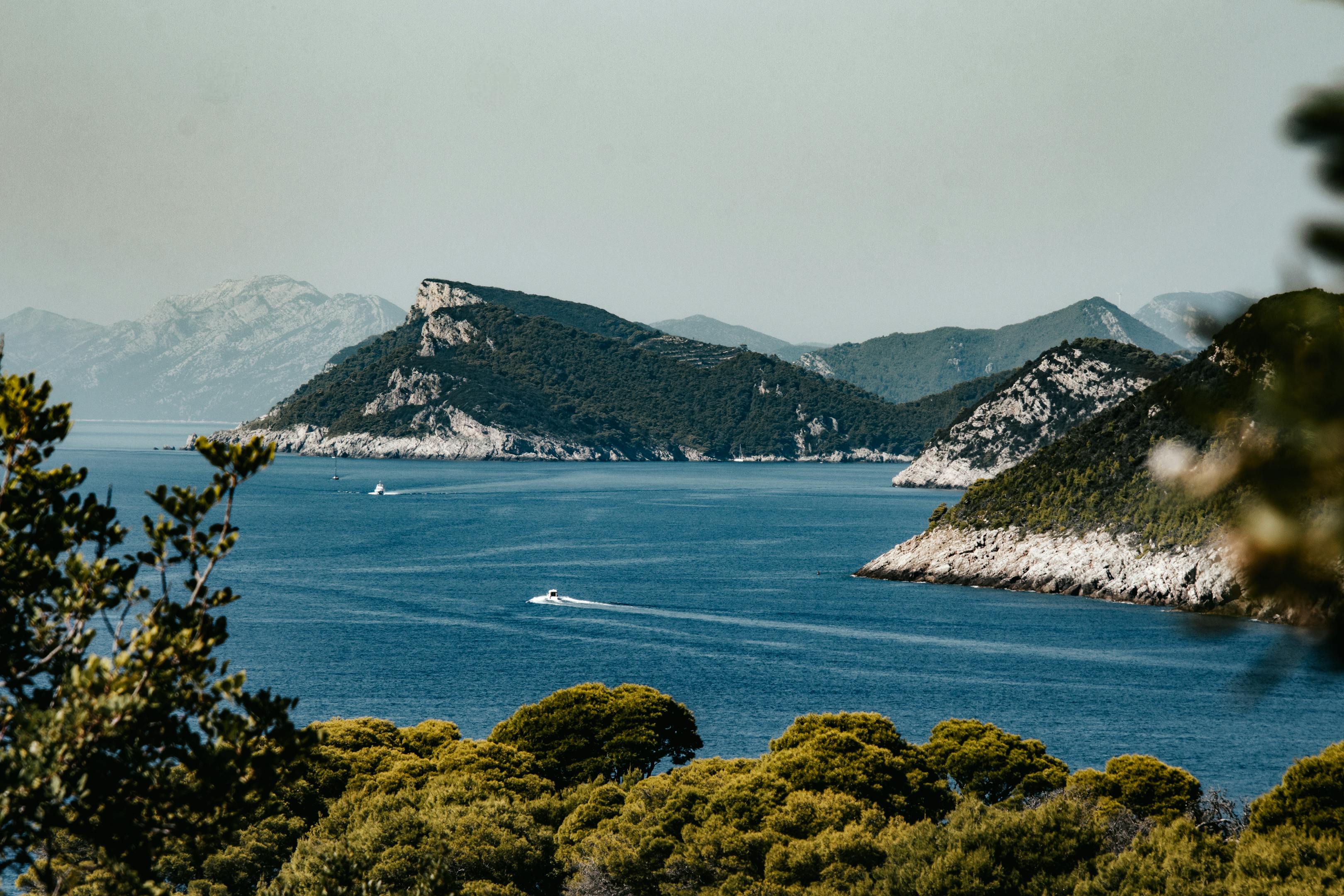 Stunning view of Lopud Island's coastline in Croatia, showcasing lush greenery and sparkling blue waters