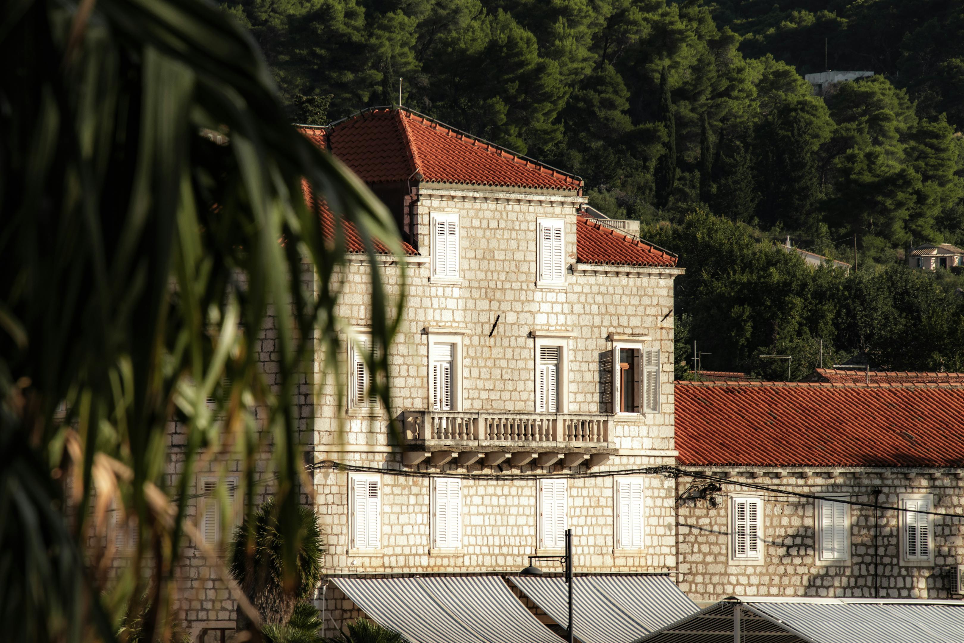 A picturesque stone building with red rooftops in Lopud island, Croatia