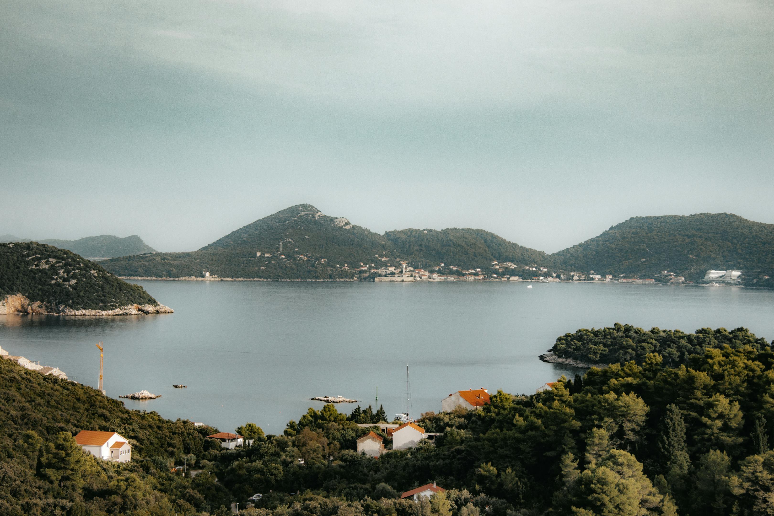 A serene landscape of Lopud Island, Croatia, captured in summer with lush greenery and calm waters