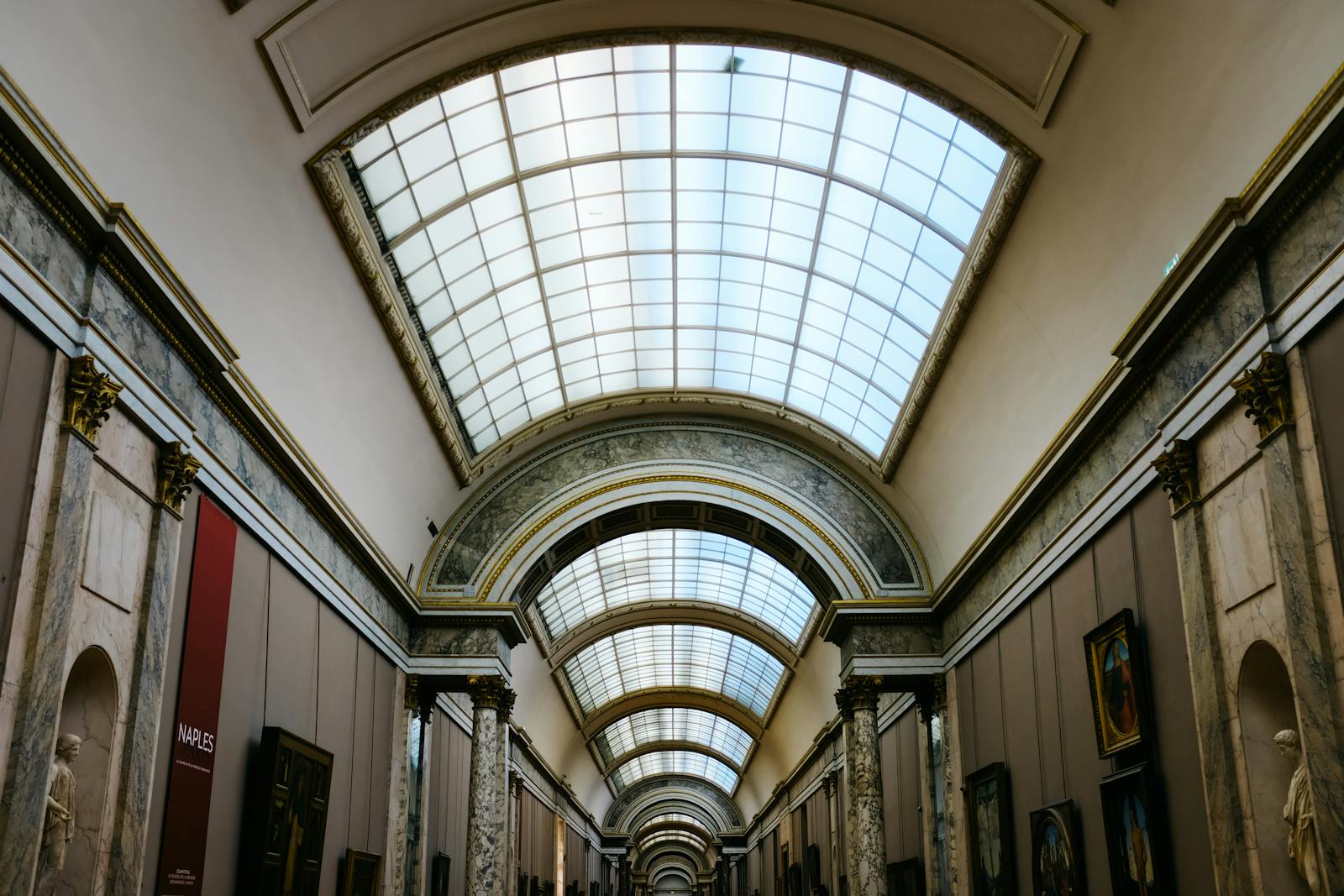 Louvre Museum grand hallway featuring an elegant glass ceiling