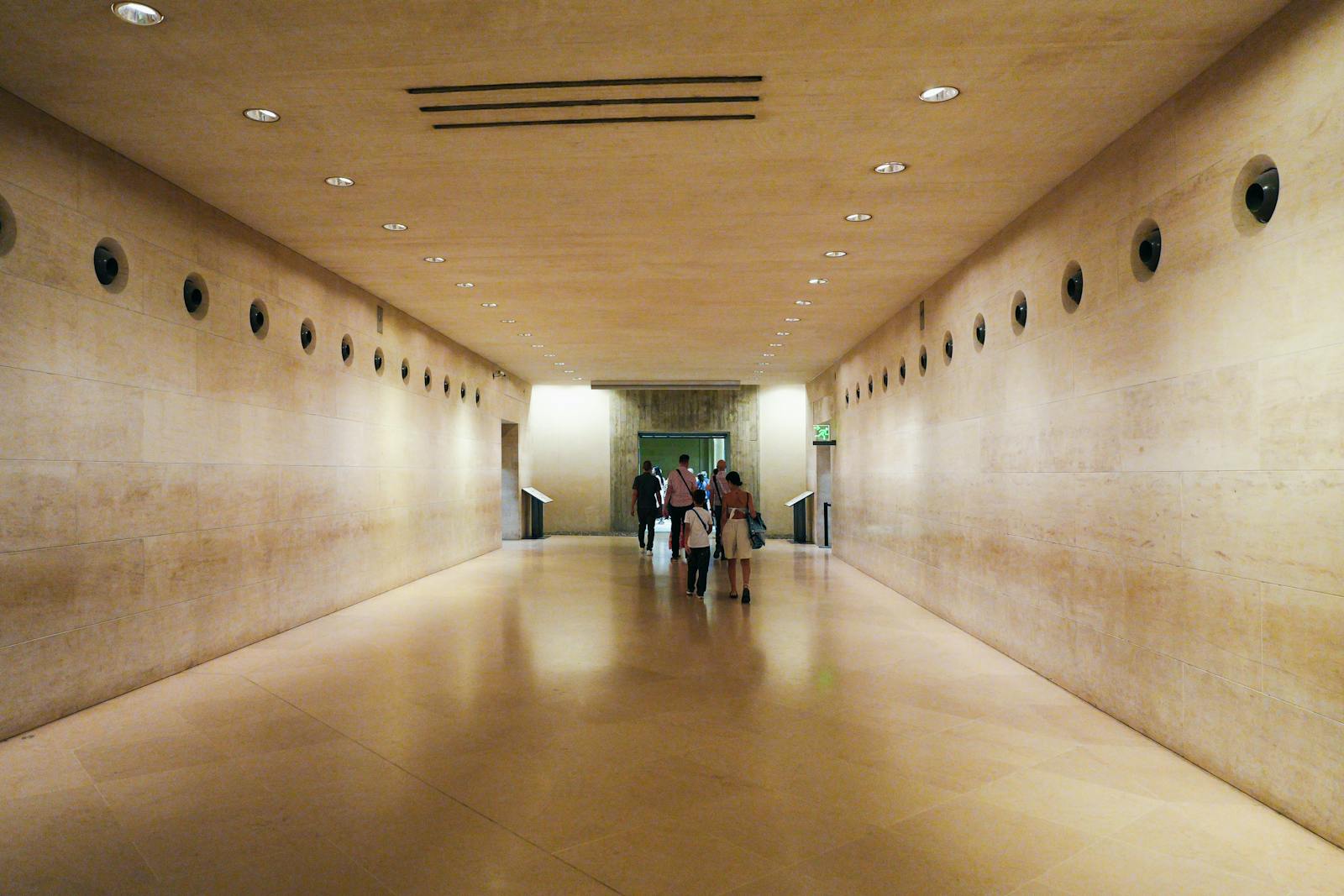 Visitors exploring a modern corridor inside the Louvre Museum in Paris