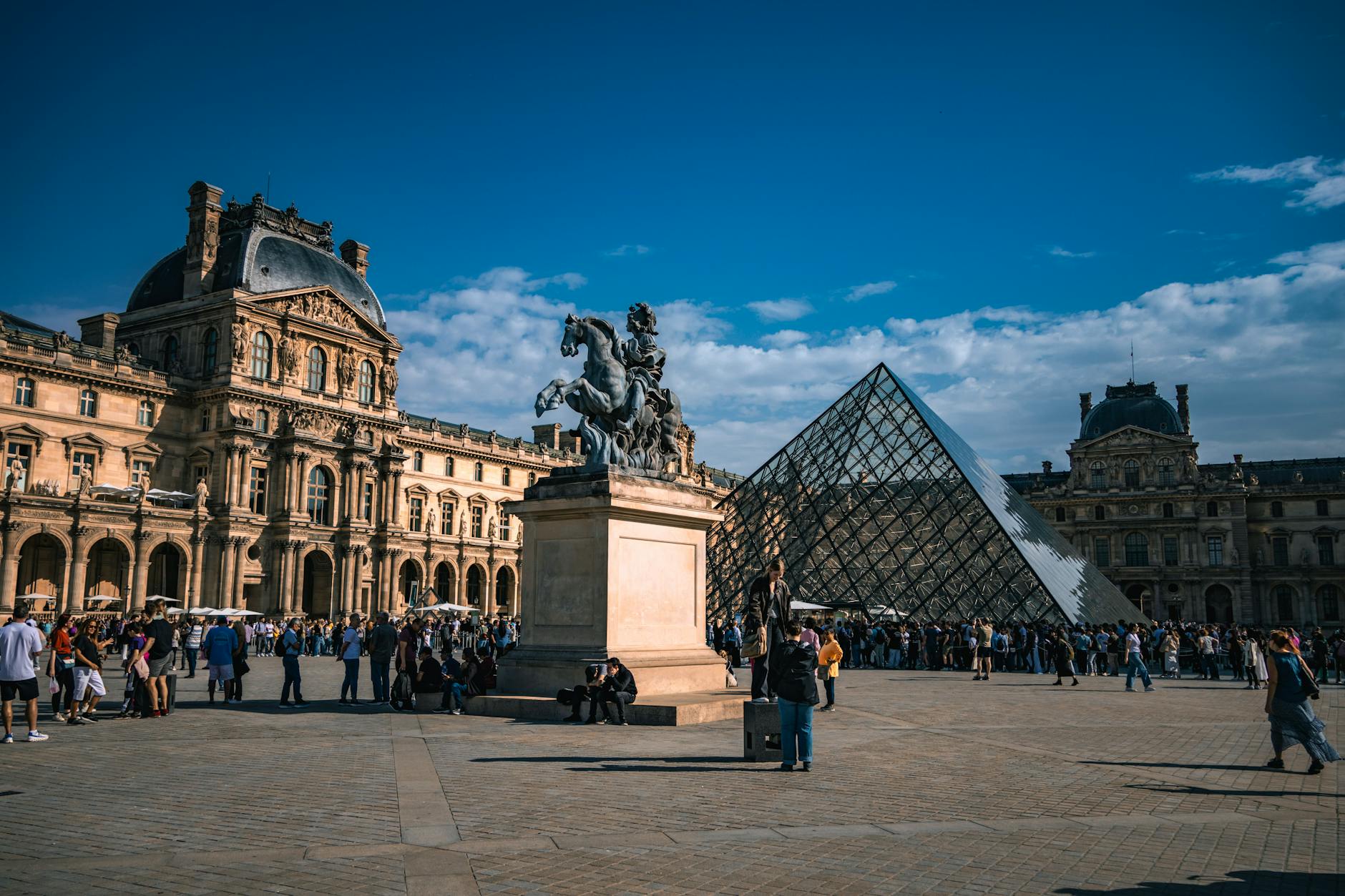The Louvre Museum with the glass pyramid in the courtyard