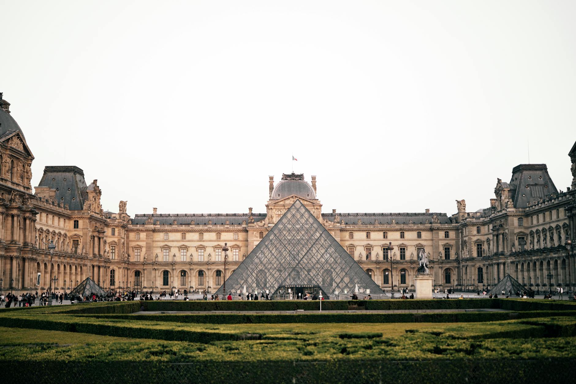 The Louvre Pyramid in the courtyard during daytime in Paris