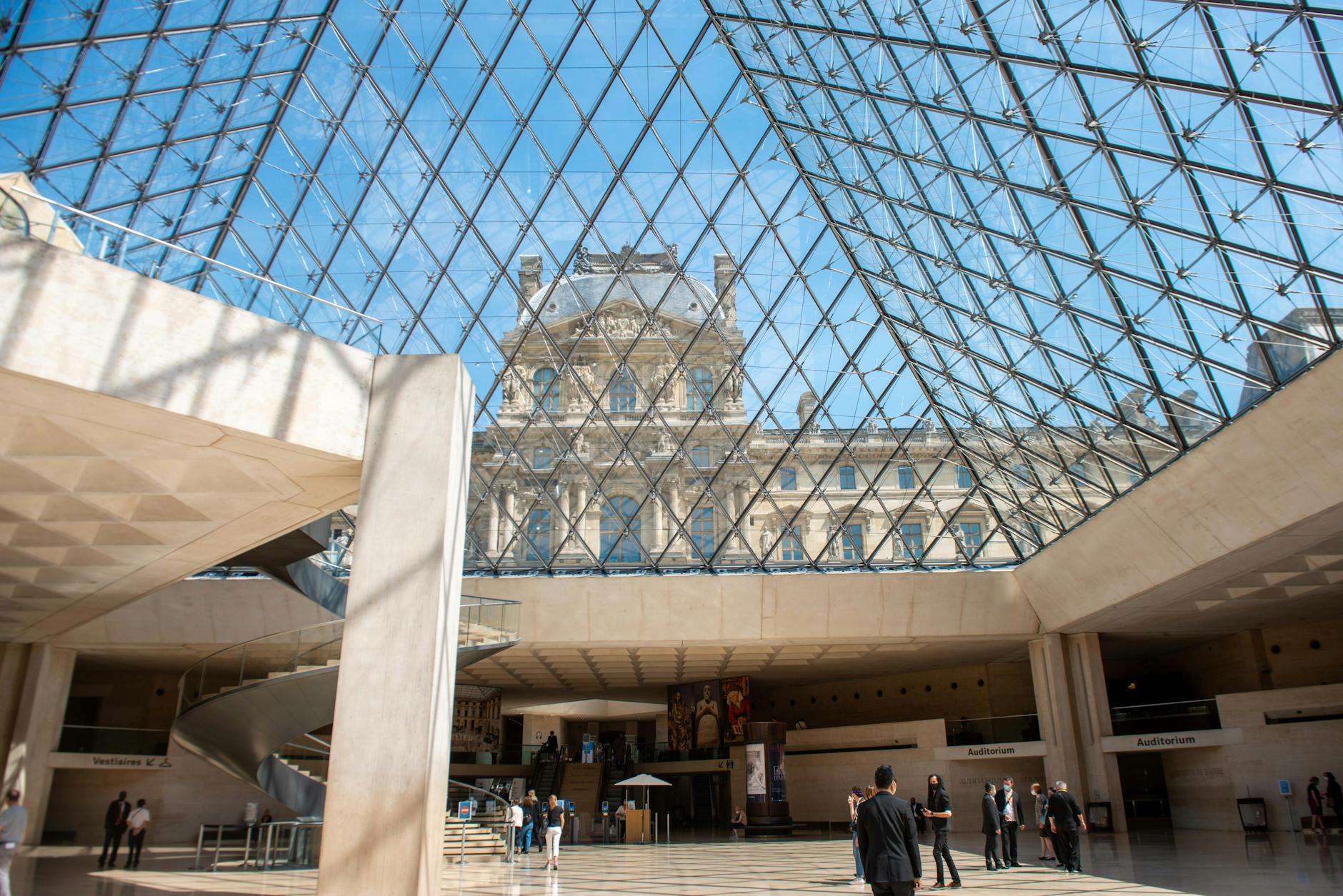 An interior architectural view of the Louvre Pyramid