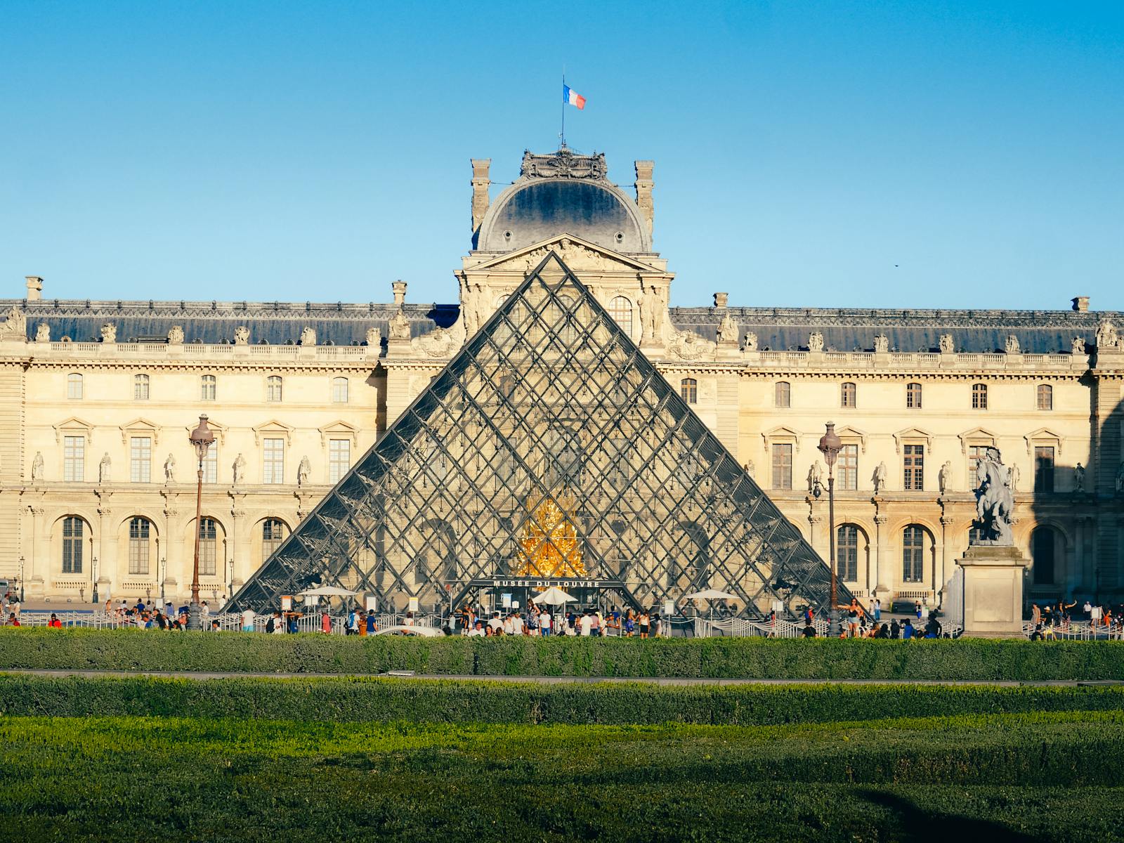 The Louvre Museum and Glass Pyramid in Paris on a clear day