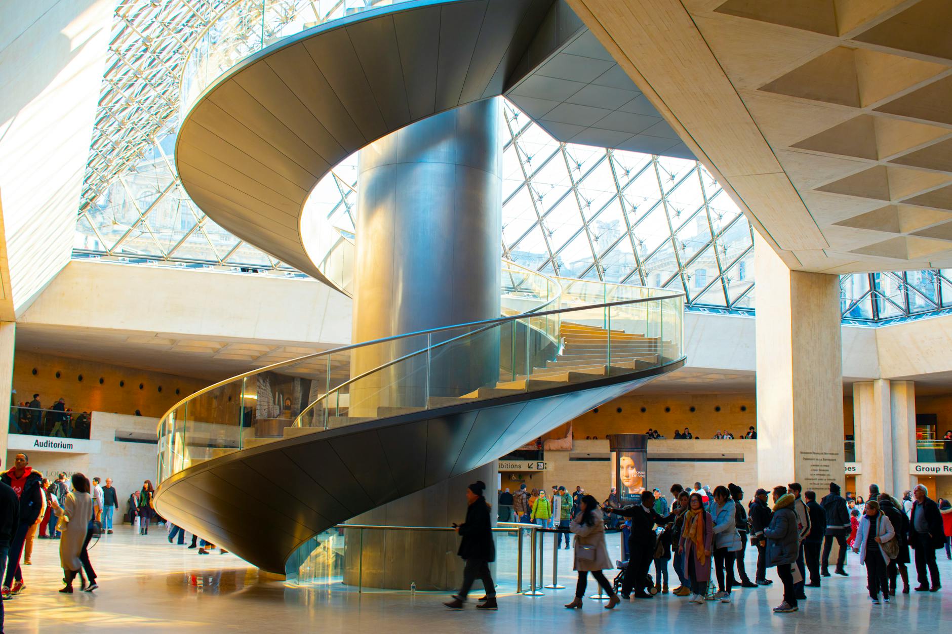 Visitors on the Louvre spiral staircase underground