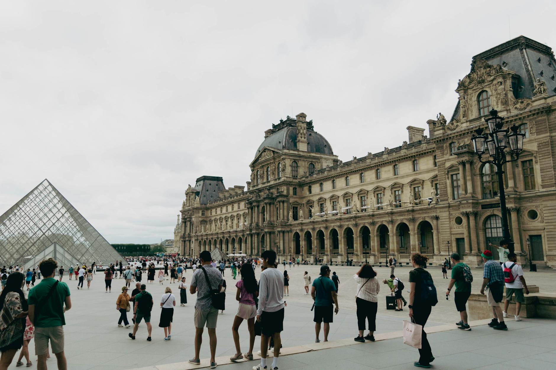 Visitors gathered around the glass pyramid at the Louvre