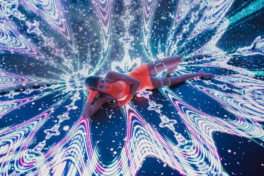 Dancer in vibrant neon attire performs digital art