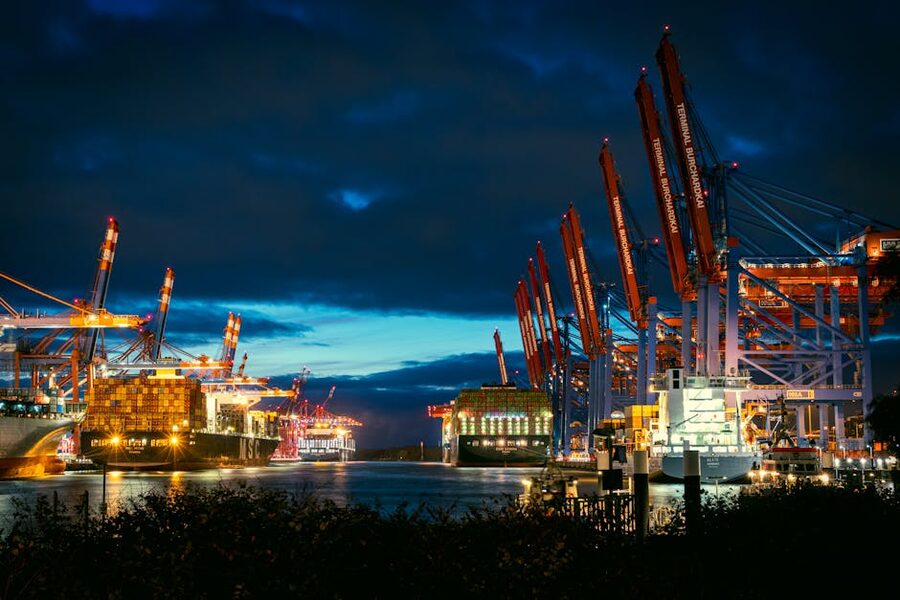 Illuminated cargo port with cranes at night