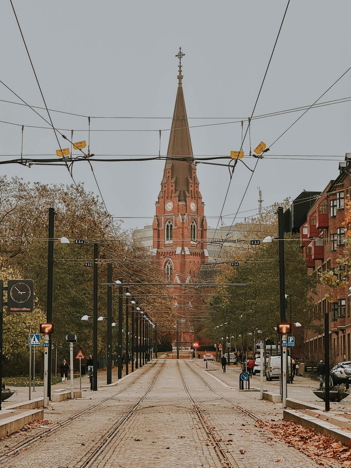 Cobblestone street leading to a historic church in Lund, Sweden during autumn