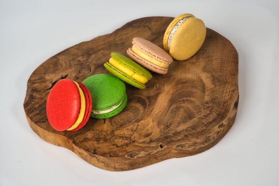 Assortment of French macarons on a rustic wooden platter