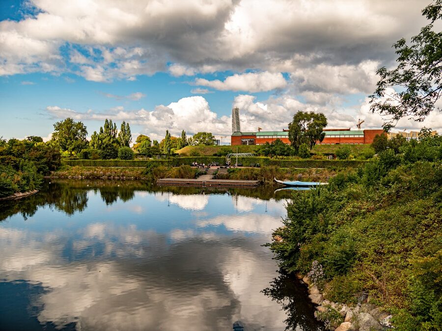 Picturesque view of a lake surrounded by greenery and buildings in Malmö Sweden