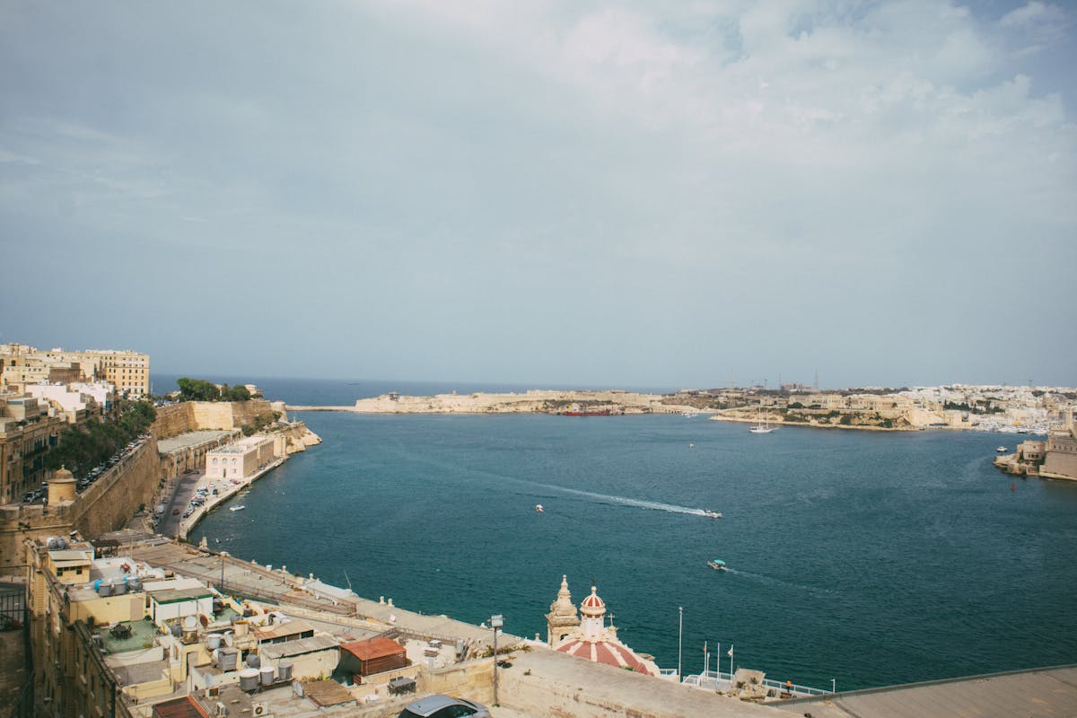 Panoramic view of Malta's Grand Harbour with historic buildings and clear skies
