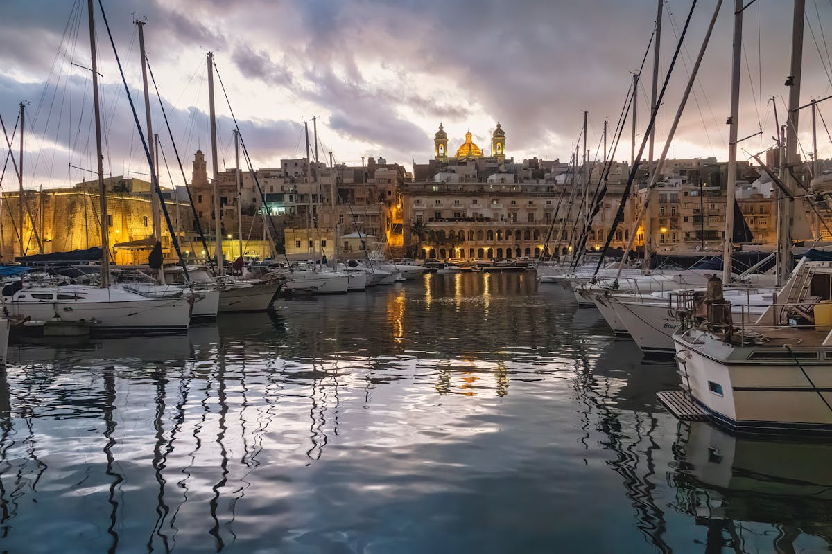 Yacht marina at sunset in Malta with historic architecture