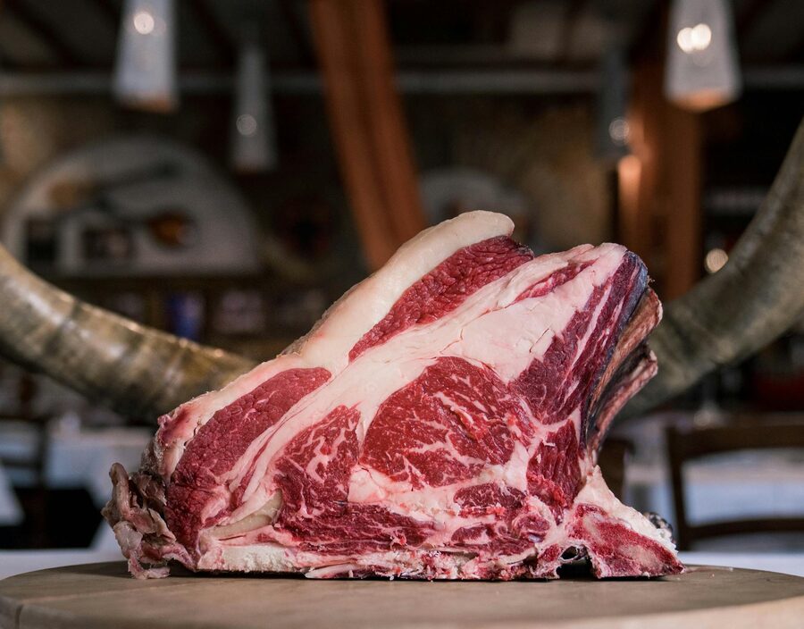 High-quality marbled beef rib on a rustic wooden table