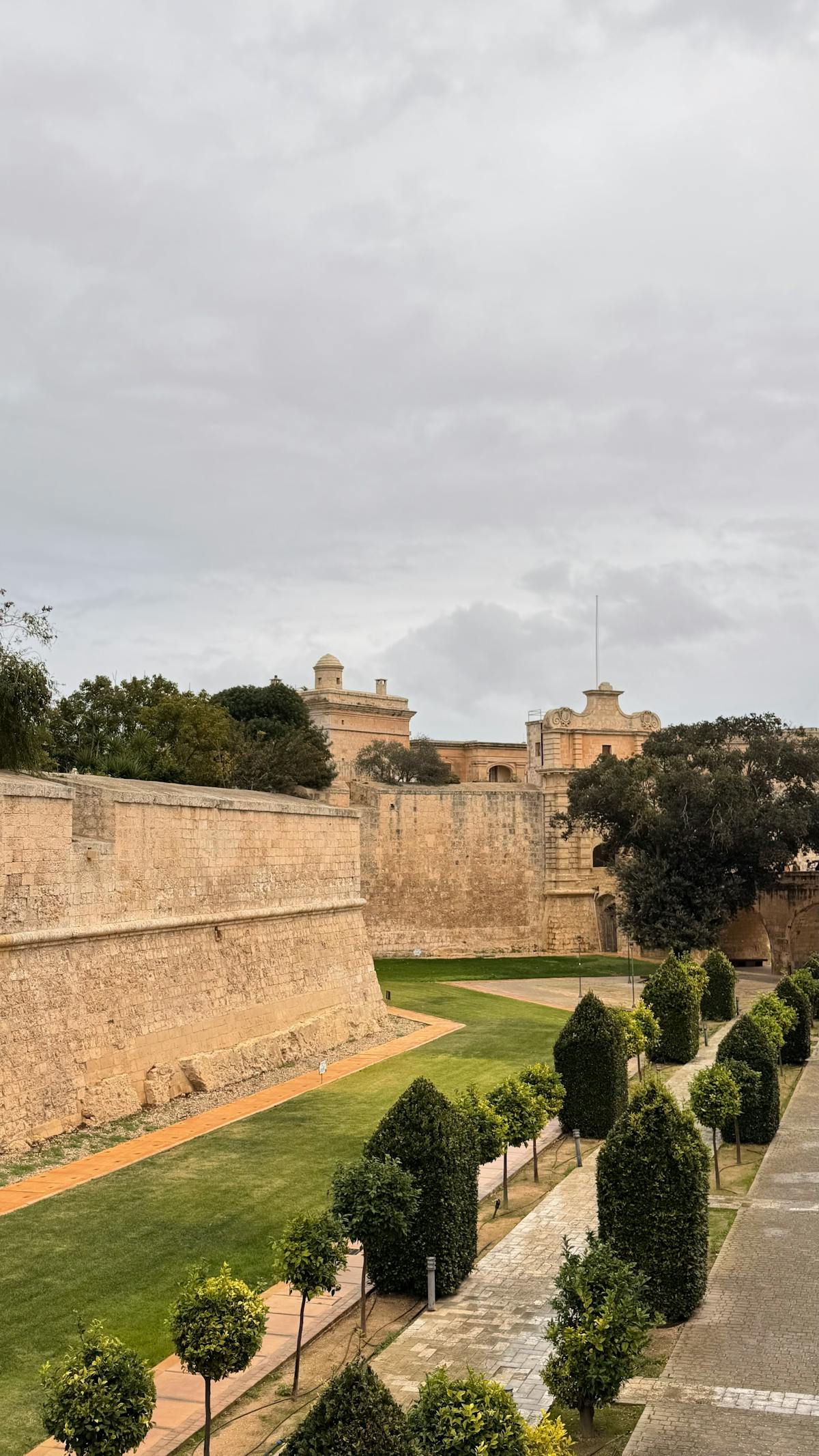 Mdina's ancient fortification walls with manicured gardens in Malta