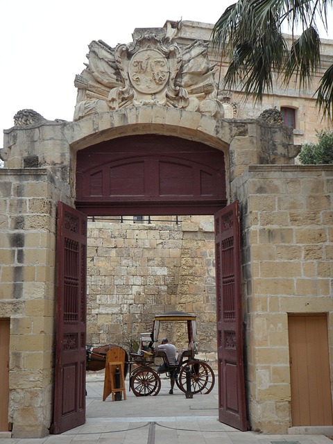 Horse-drawn carriage at the historic gate of Mdina, Malta