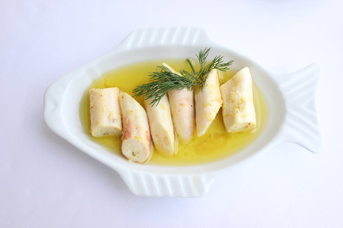 Mediterranean seafood dish with olive oil and fresh herb garnish