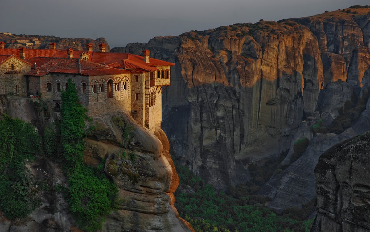 Sunset view of Great Meteoron Monastery perched on a cliff