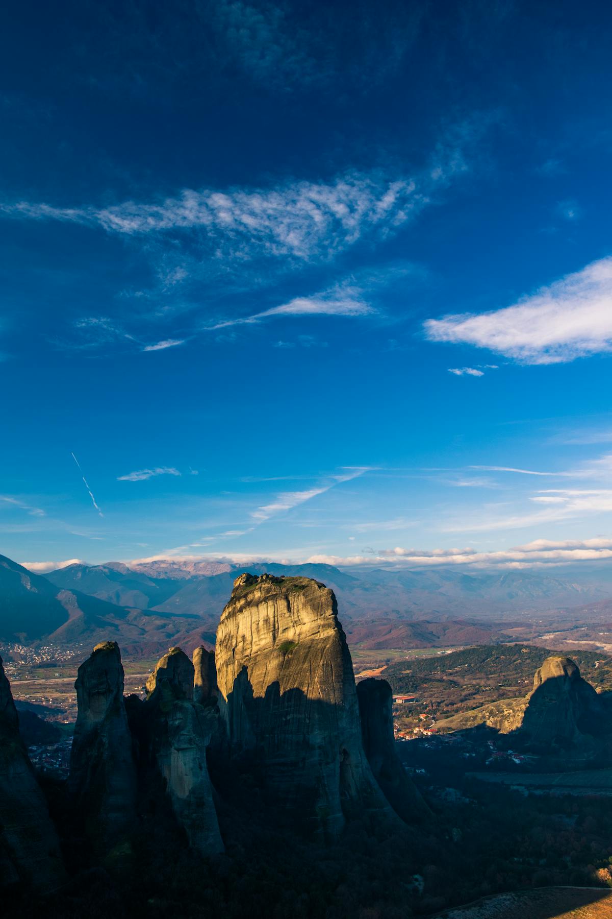 Meteora rock formations against a vibrant sunset sky