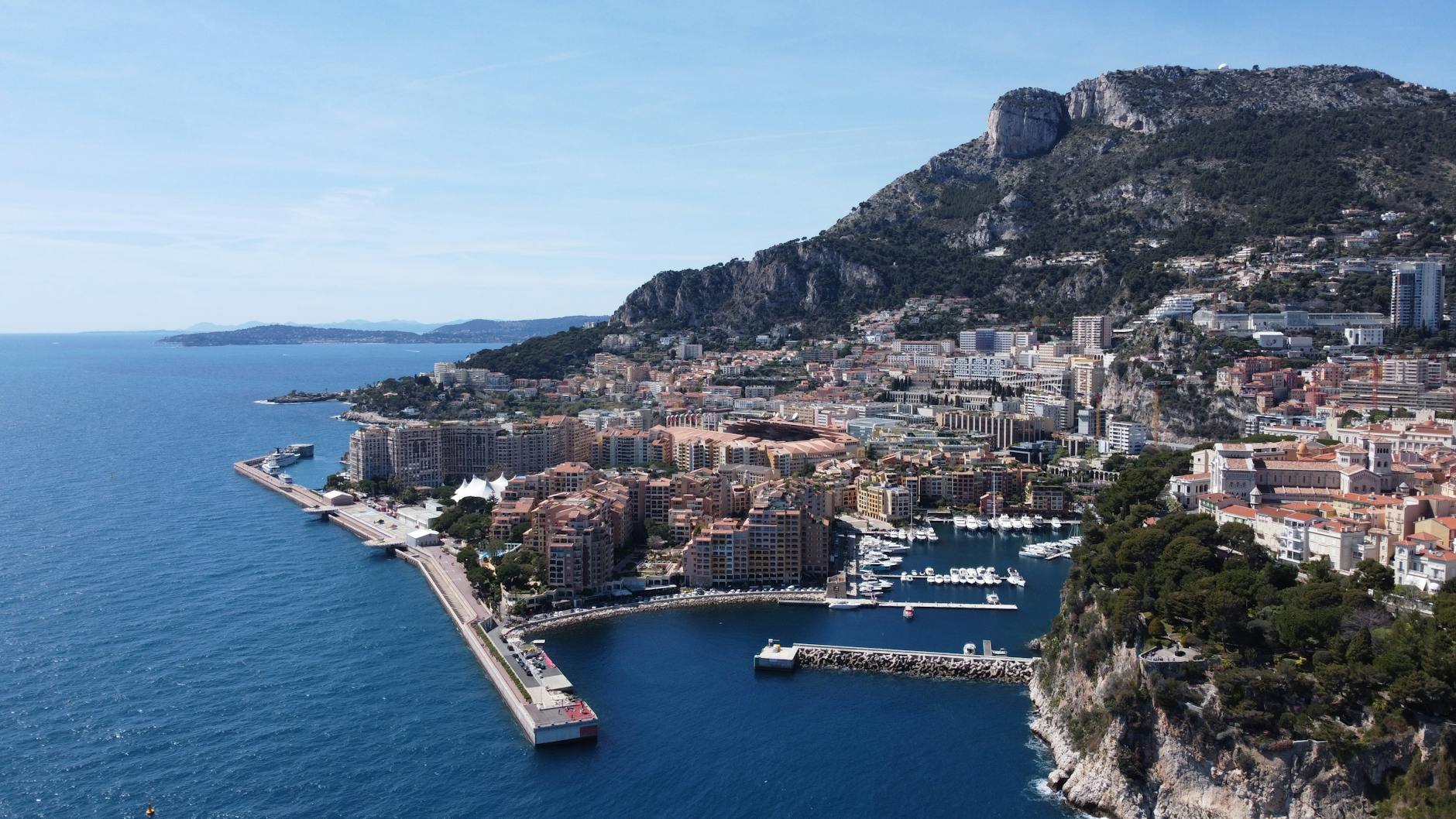 Aerial view of Monaco showcasing the cityscape harbor and surrounding mountains