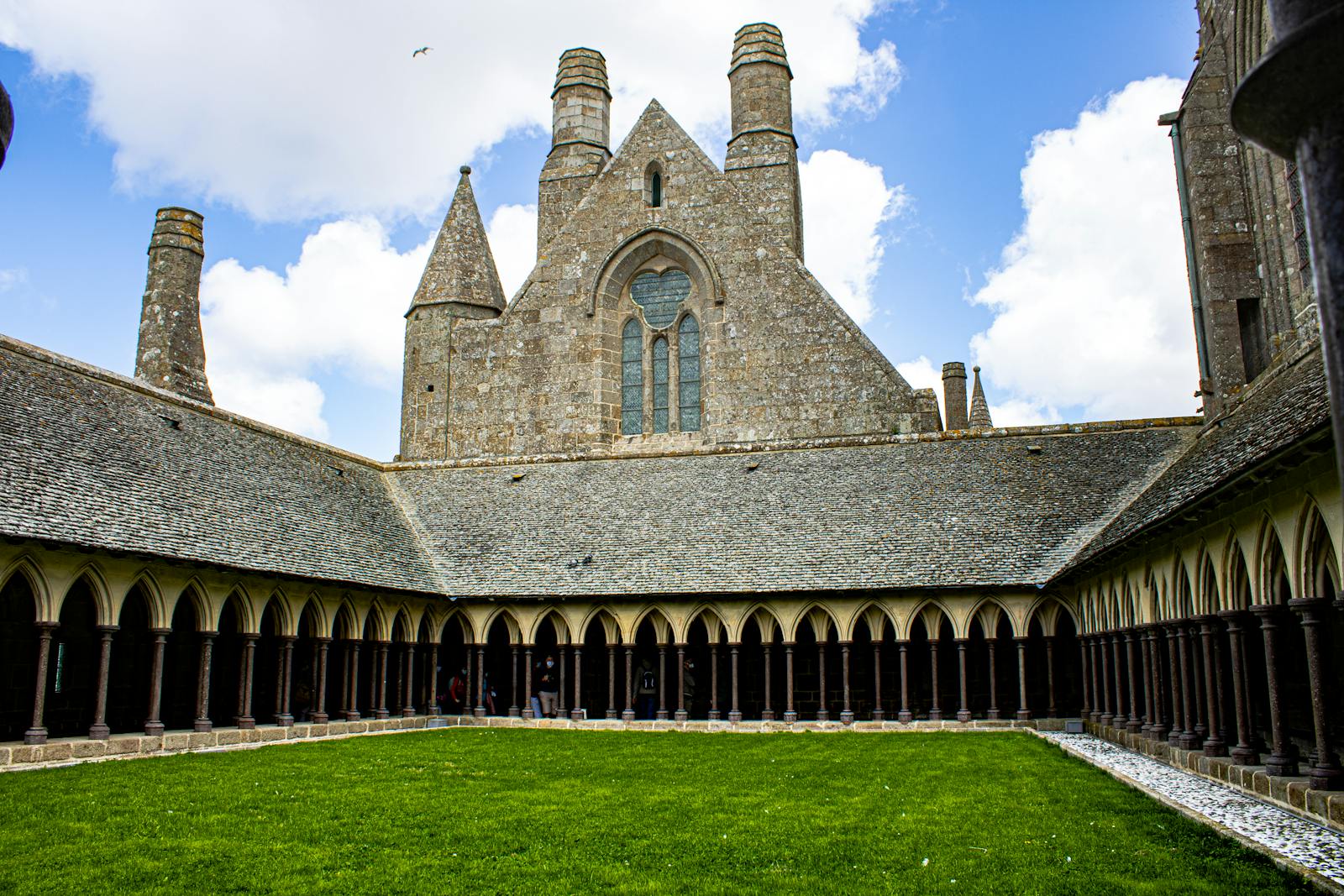 Historic courtyard inside Mont Saint-Michel Abbey under a bright sky