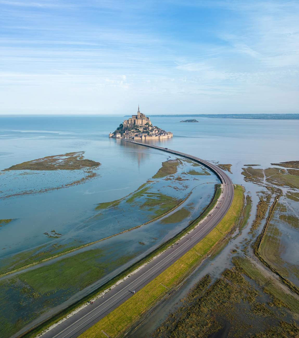 Aerial shot of Mont Saint-Michel surrounded by sea in Normandy France