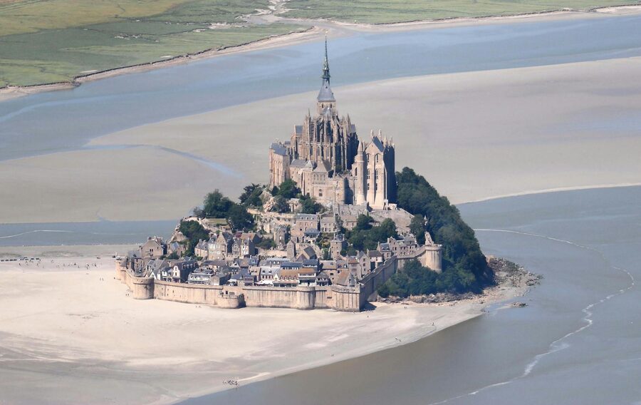 Aerial view of Mont Saint-Michel surrounded by tidal waters in Normandy