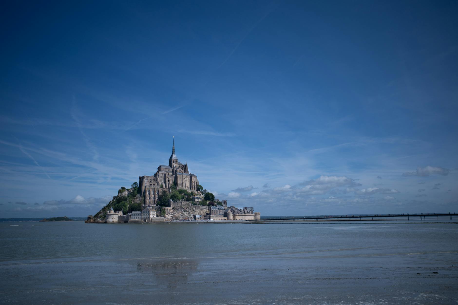 Mont Saint-Michel under a bright blue sky in Normandy