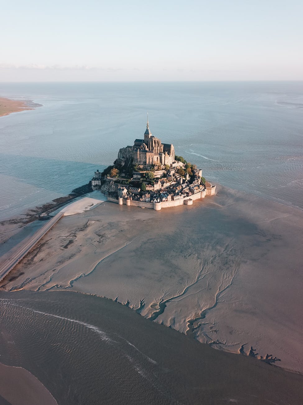 Aerial view of Mont Saint-Michel fortress during low tide