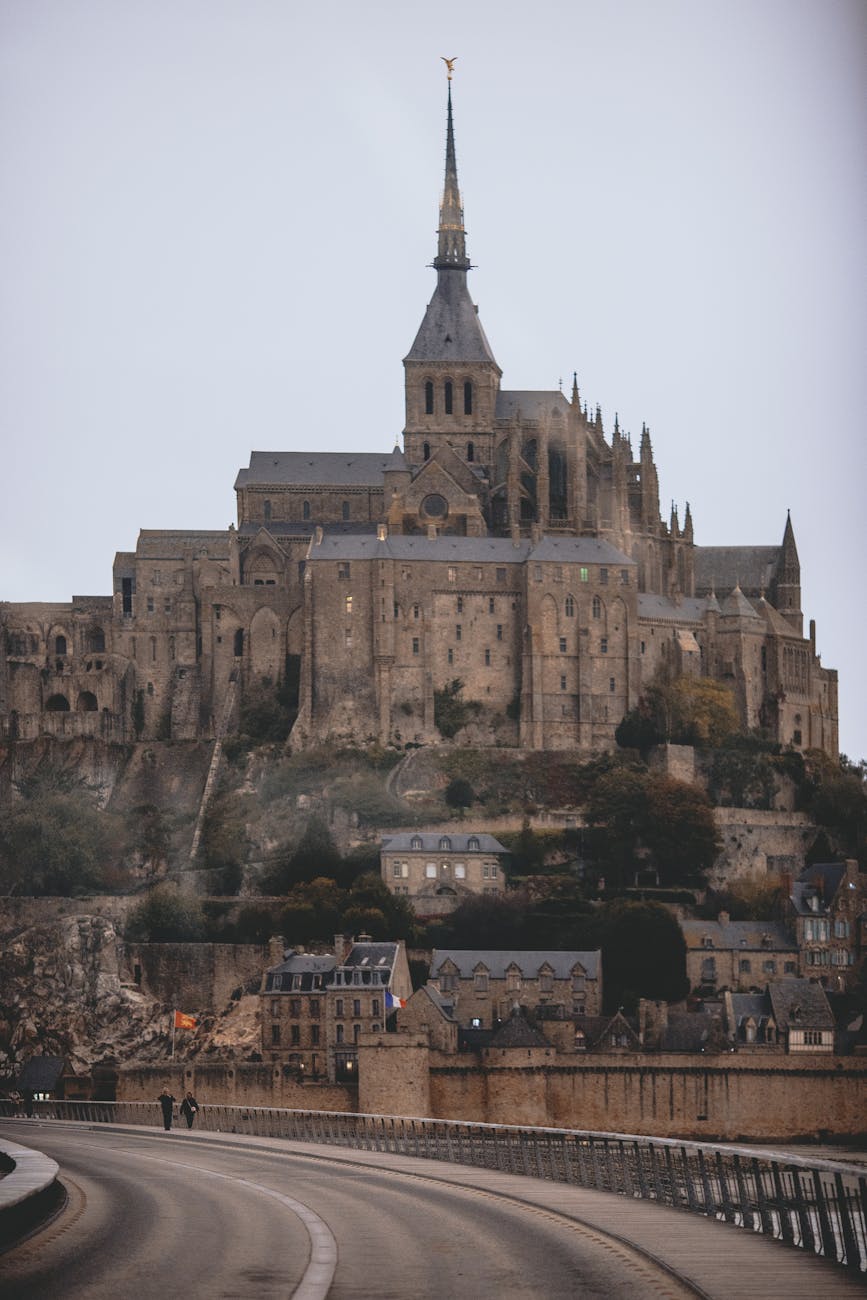 Gothic Mont Saint-Michel Abbey against a cloudy Normandy sky
